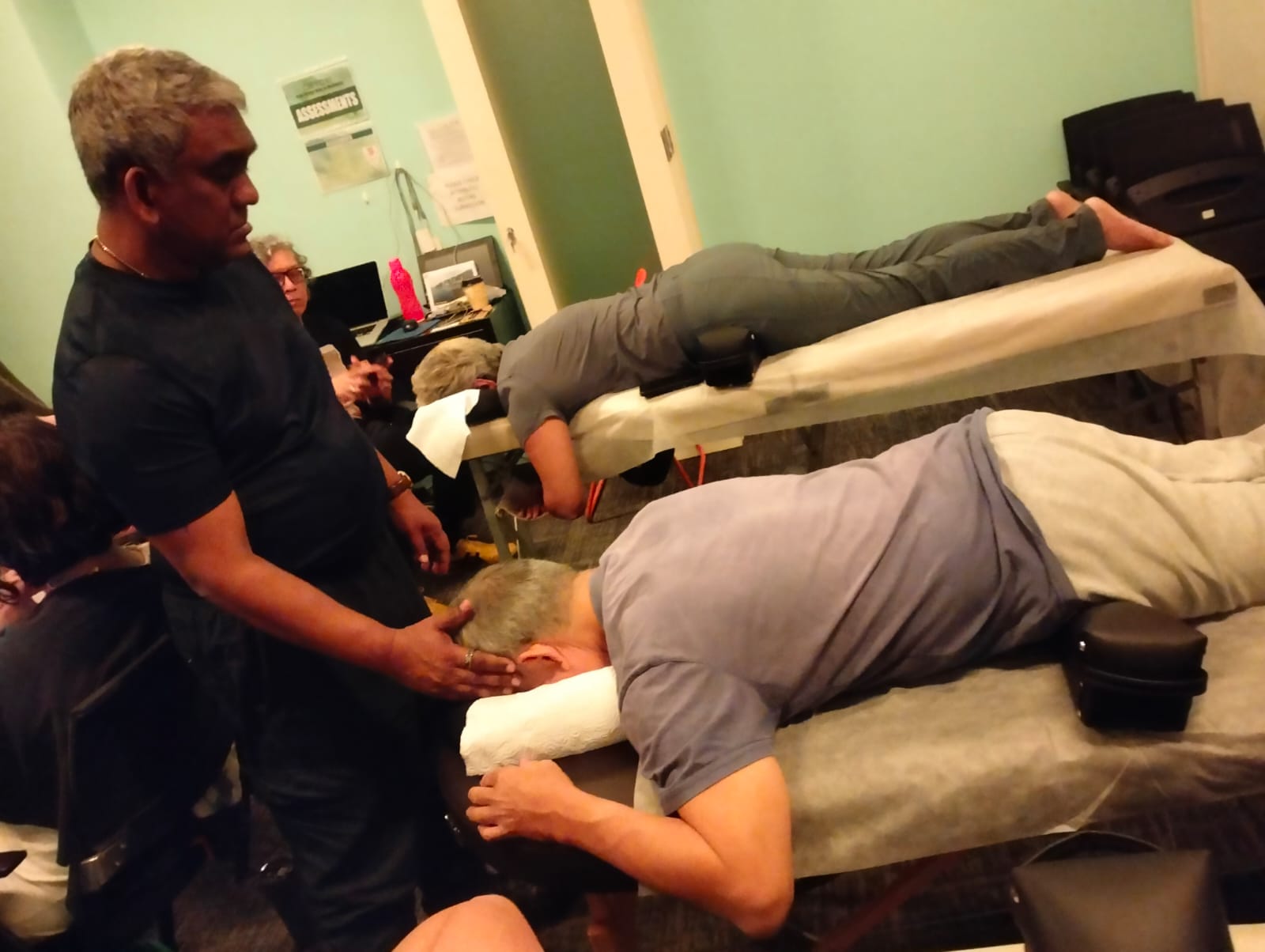 Cranial hold applied to a participant during a Somatic Osteopathy group session at the clinic